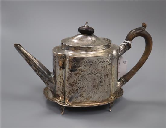 A George III bright cut silver teapot of shaped oval form, London 1815, maker Solomon Hougham, with matching stand, 17.2oz